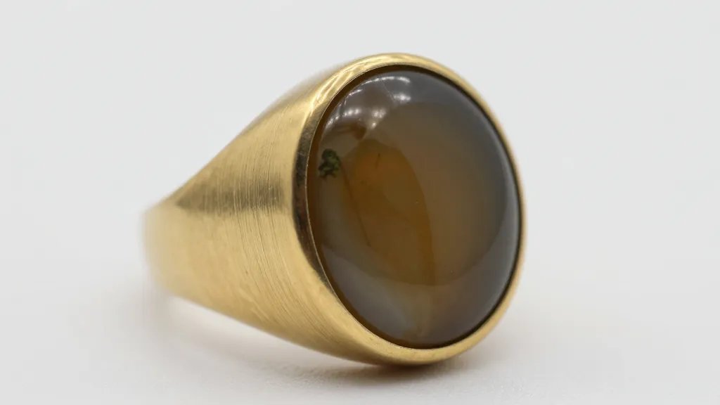 closeup of moss agate signet ring with brushed brass finish
