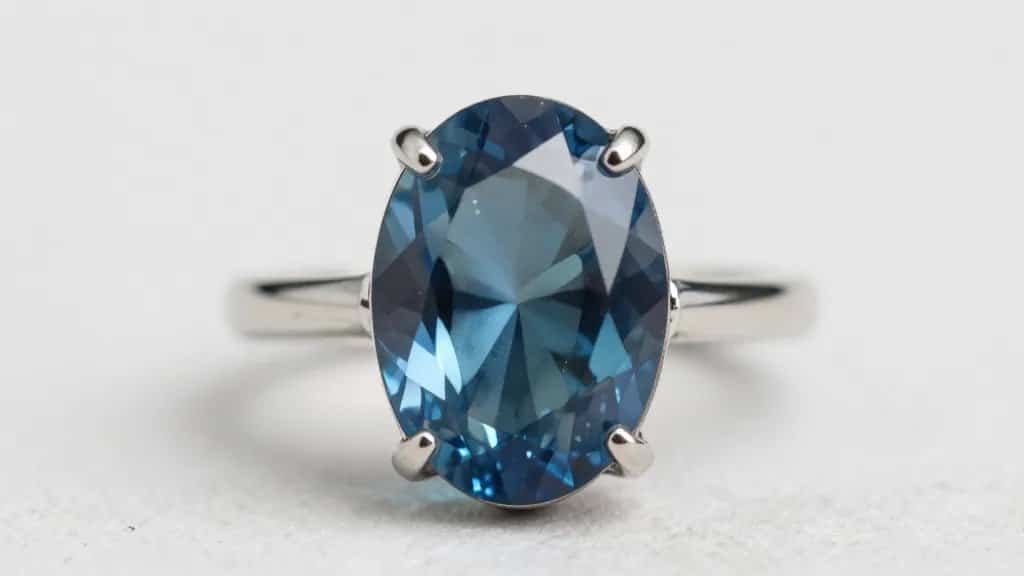 closeup oval London blue topaz ring in bezel setting