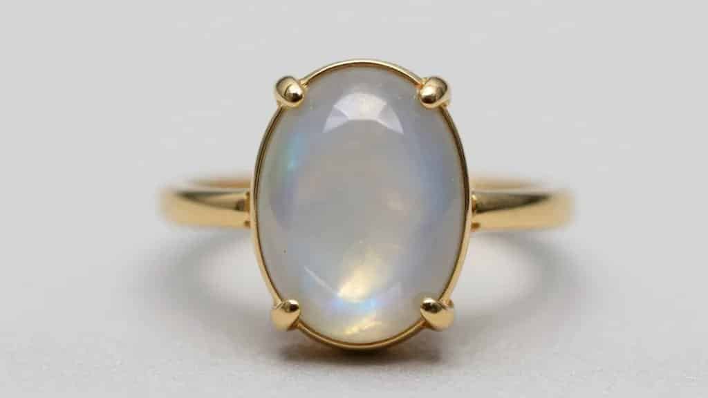 closeup oval moonstone cabochon ring in 14k gold