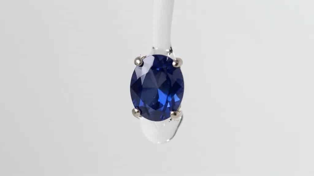sapphire stud earring under running lukewarm rinse, macro shot