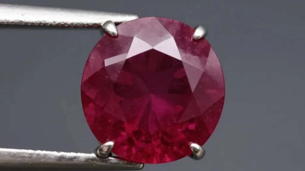 macro shot of pigeon‑blood ruby in platinum prong