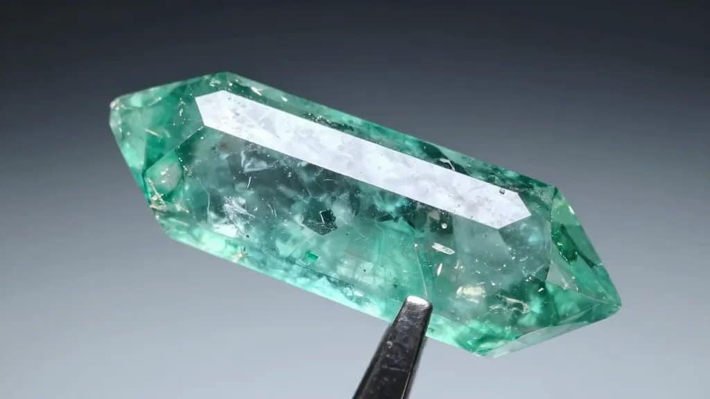 single vivid green tourmaline crystal with razor-sharp termination