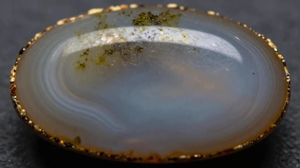 polished moss agate cabochon, extreme closeup on banding