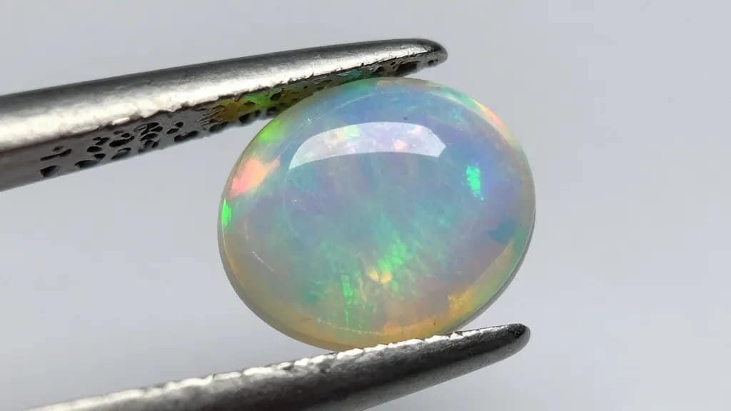 Single polished opal cabochon showing vivid play-of-color