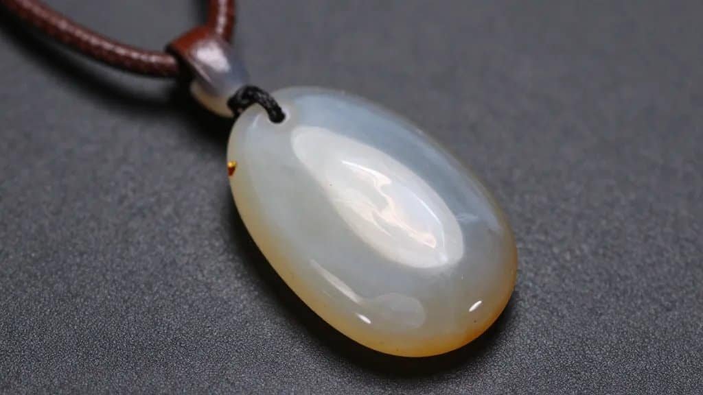 closeup polished agate pendant on leather cord