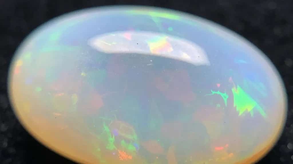 closeup of polished opal showing play-of-color fire