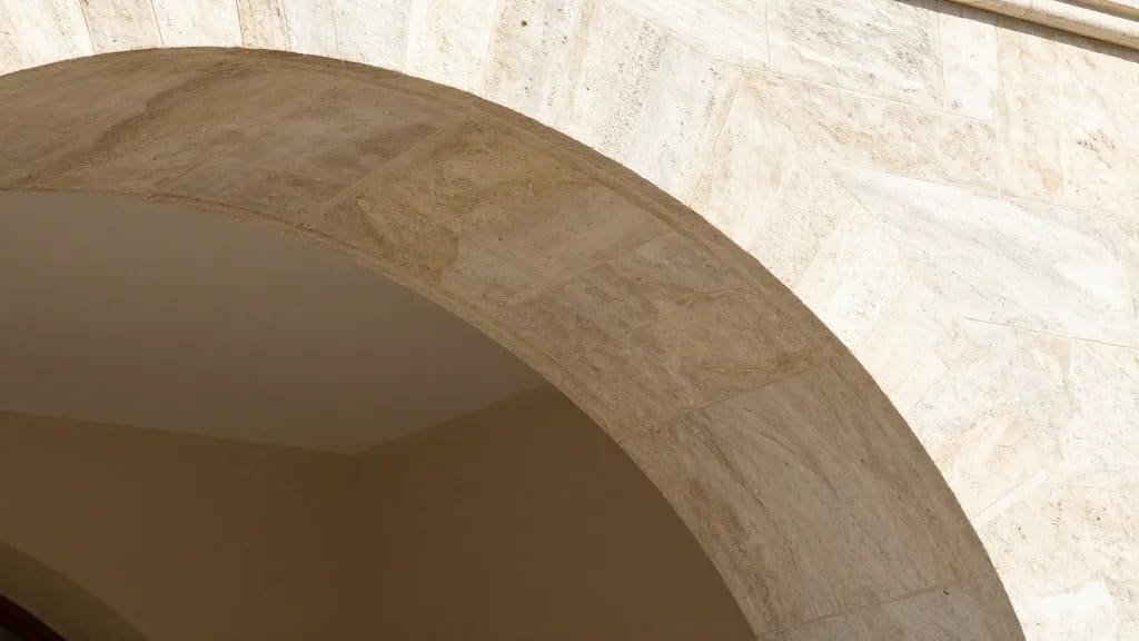 closeup of natural stone arch curve, cross-polarized sunlight